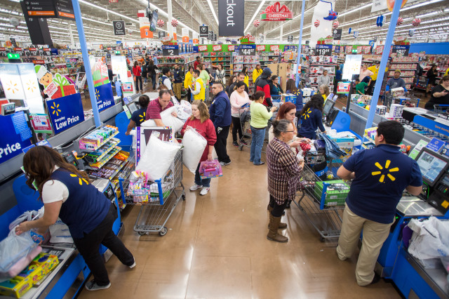 Cashiers at work at Walmart. About 3.4 million Americans work as cashiers. (AP Photo) 